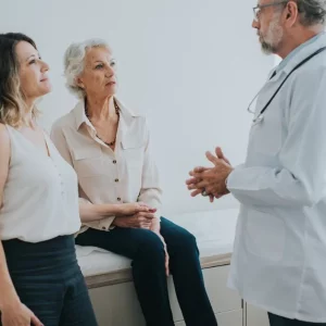 doctor talking to woman and daughter about high cholesterol and stroke