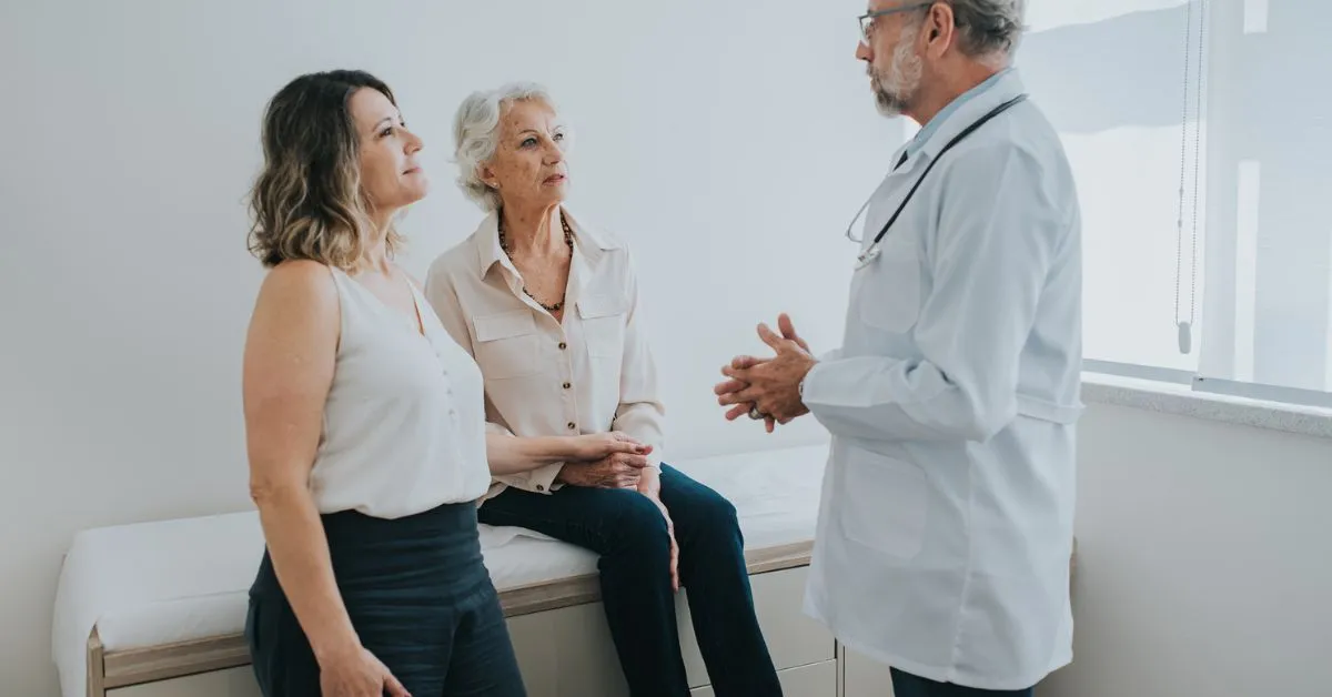 doctor talking to woman and daughter about high cholesterol and stroke