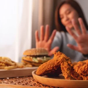 woman showing example of certain foods to avoid after stroke