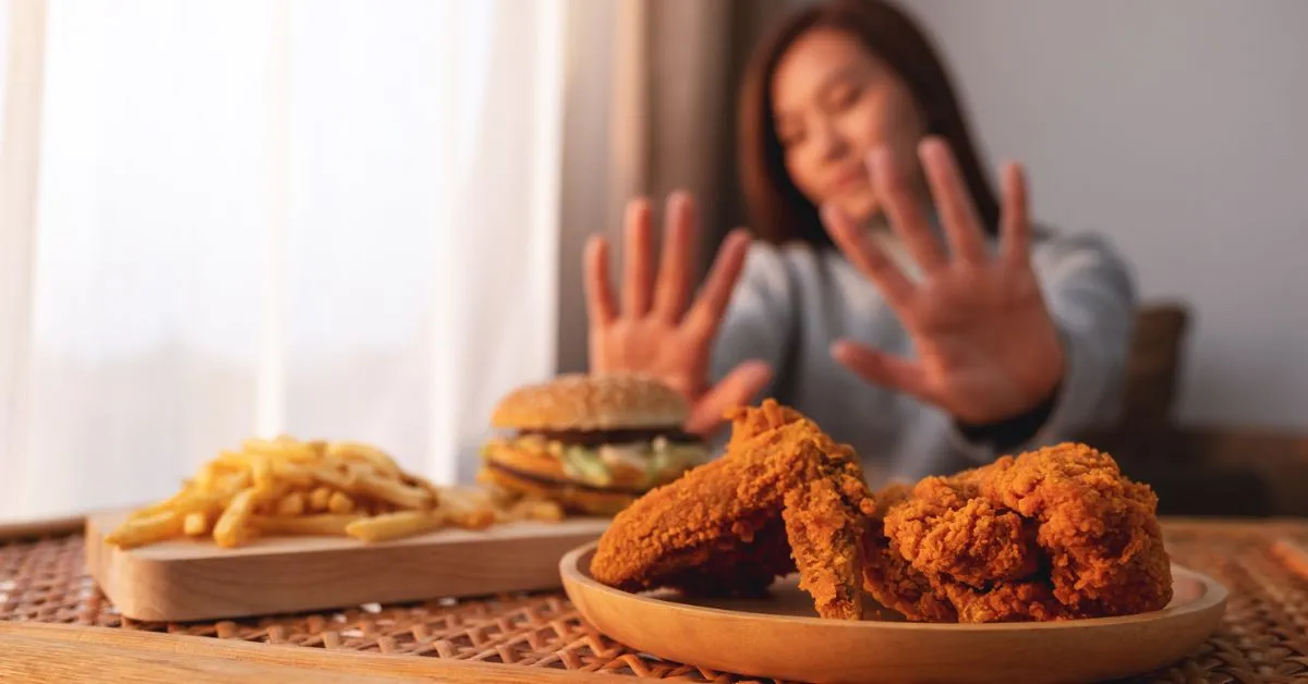 woman showing example of certain foods to avoid after stroke