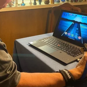man using physical therapy tools for hands called the musicglove