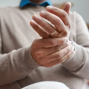 man with alien hand syndrome after brain injury holding his hand