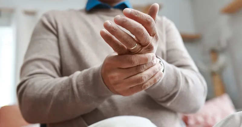 man with alien hand syndrome after brain injury holding his hand