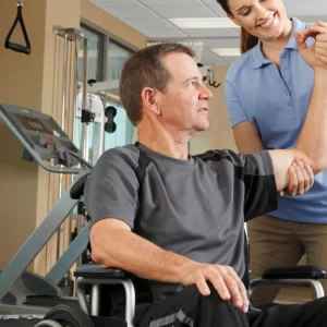 man recovering after spinal cord injury doing rehab with a therapist