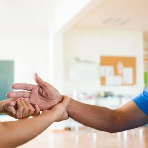 man stretching hand for spasticity after stroke