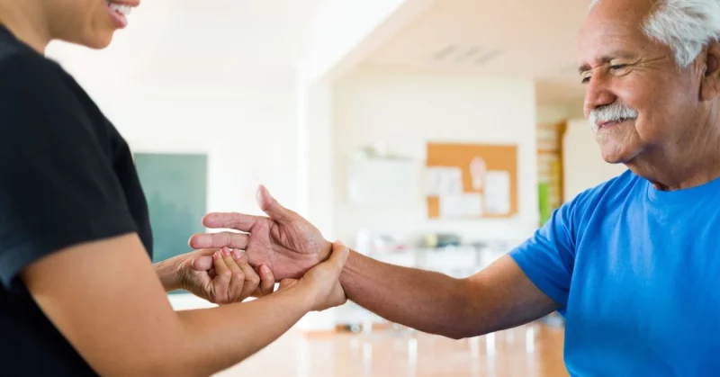 man stretching hand for spasticity after stroke