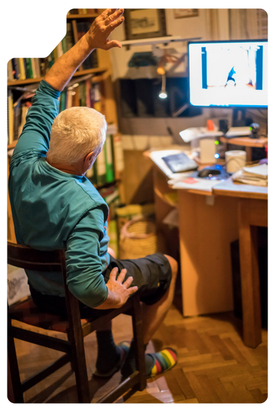man doing virtual physical therapy watching exercise on computer