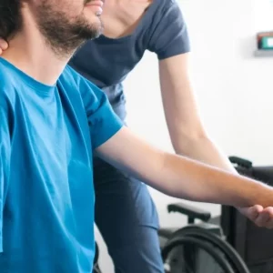 man with c5 spinal cord injury working with home rehab tools