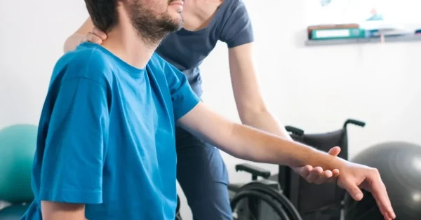 man with c5 spinal cord injury working with home rehab tools