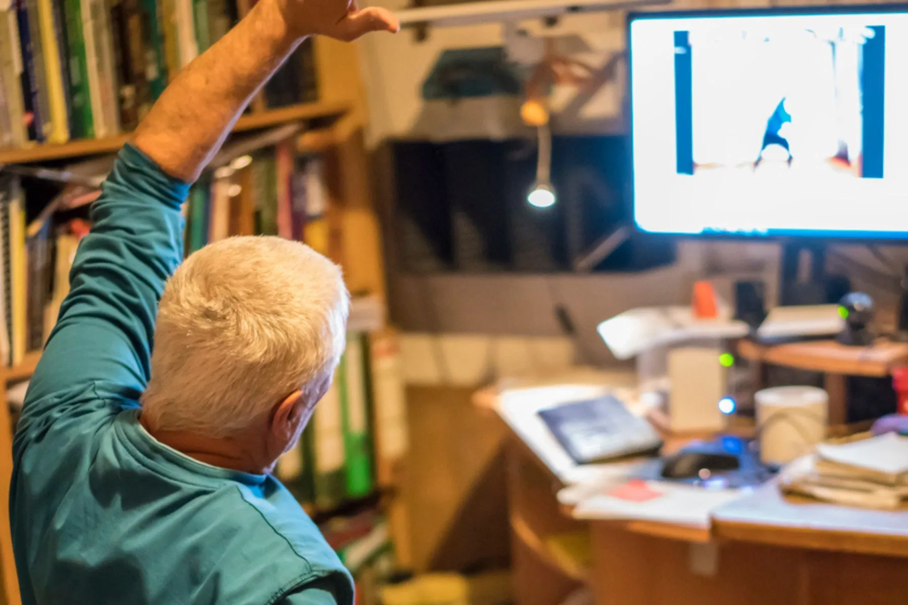 man exercising at home through remote neuro rehab and physical therapy