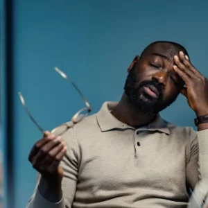 man with fatigue after stroke at his desk