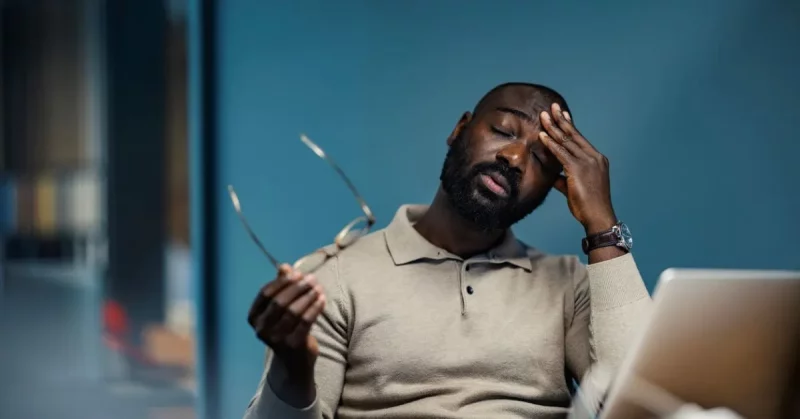 man with fatigue after stroke at his desk