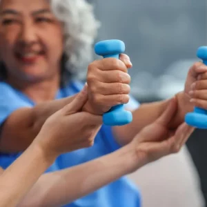 woman working on breaking through her stroke recovery plateau