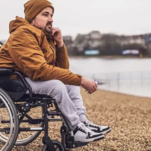 man with depression after spinal cord injury looking out at the water