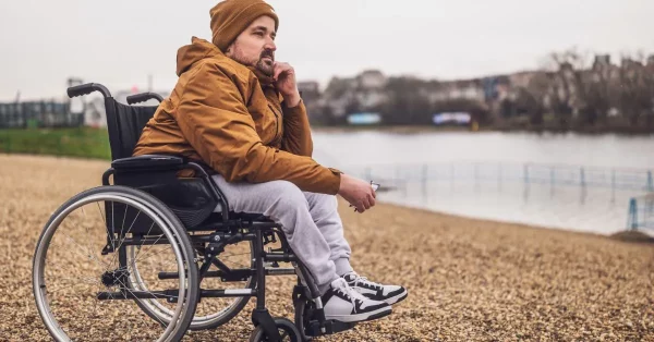 man with depression after spinal cord injury looking out at the water