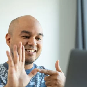 man on virtual physical therapy video call with therapist