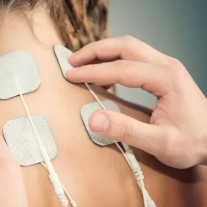woman using a tens electrical stimultion therapy
