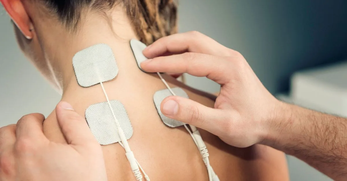 woman using a tens electrical stimultion therapy