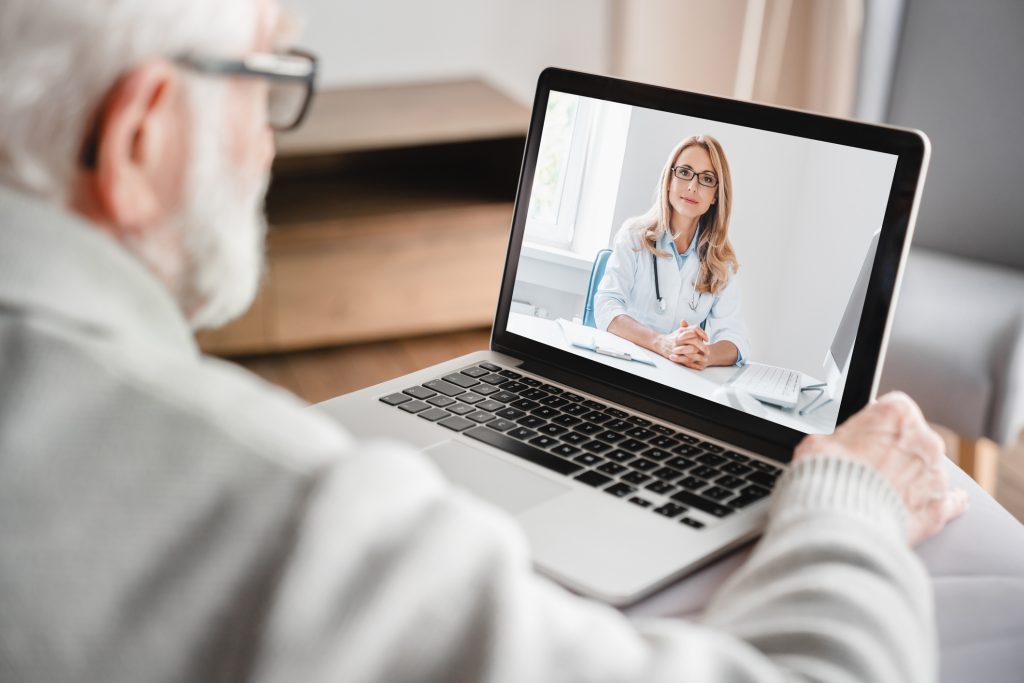 A therapist coaching a home session over video