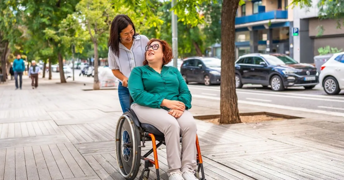 woman with multiple sclerosis and bladder problems being wheeled around